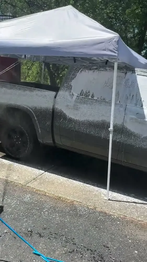 Aquarius pressure washing a truck covered in foam