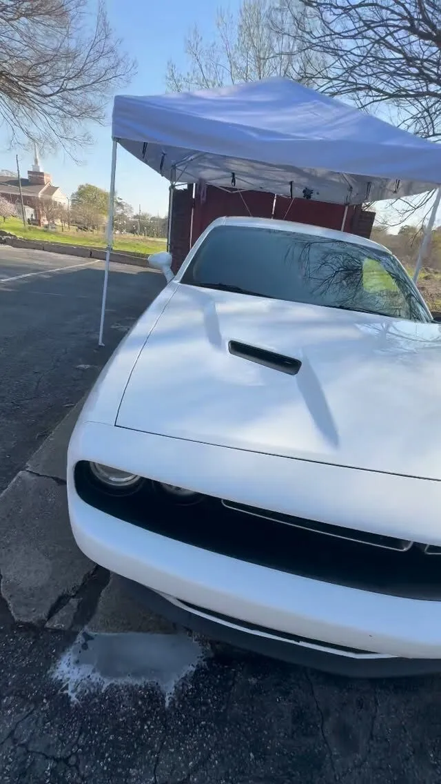 A white Dodge Challenger at the Aquarius mobile wash setup
